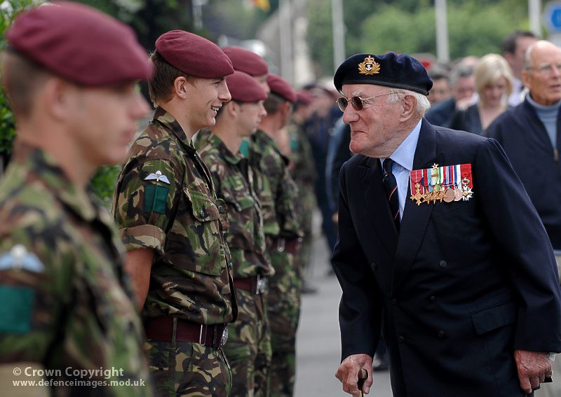 A Royal Navy Veteran Shares a Joke With a Young Paratrooper