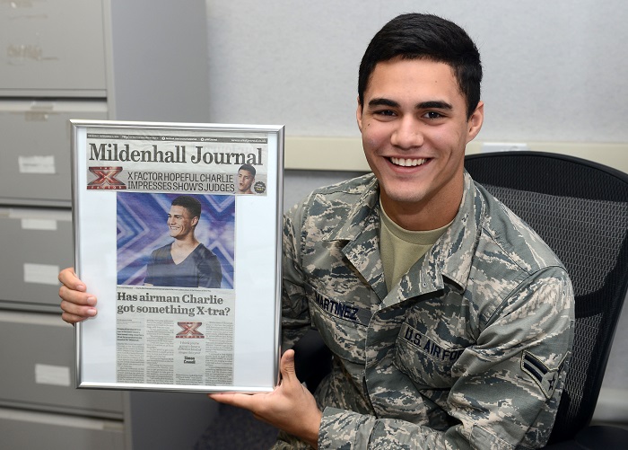 U.S. Air Force Airman 1st Class Charlie Martinez, 100th Force Support Squadron force management apprentice from Orlando, Fla., 
                  poses for a photograph with a newspaper clipping of himself Oct. 15, 2014, on RAF Mildenhall, England. 
                  The clipping was from Martinez's time on X Factor United Kingdom, a televised British singing competition.